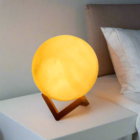 Moon lamp on a nightstand next to a bed