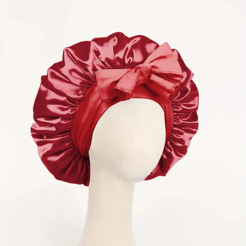 Red satin bonnet with a bow on a mannequin head against a white background
